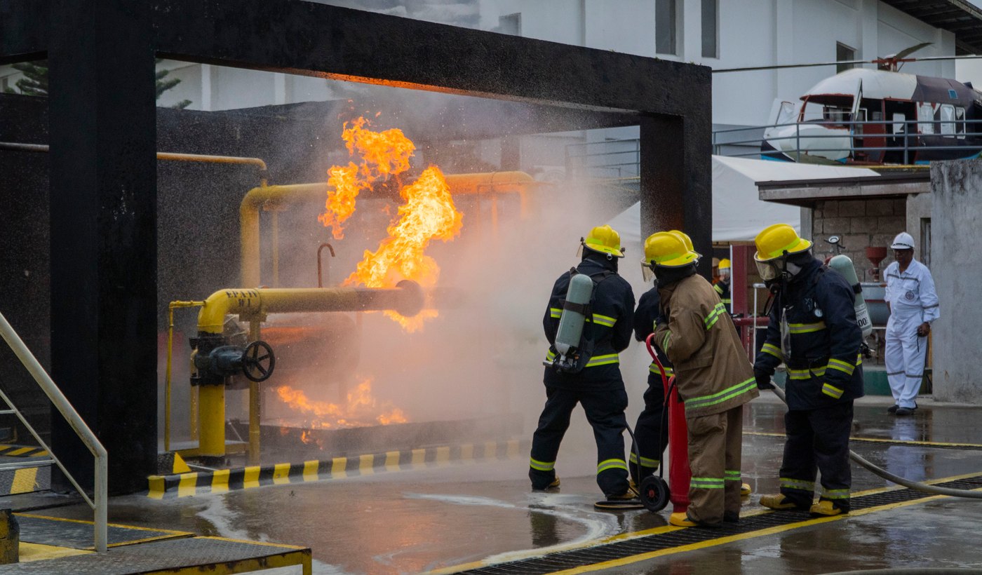 Firefighters conducting a practical live-fire exercise