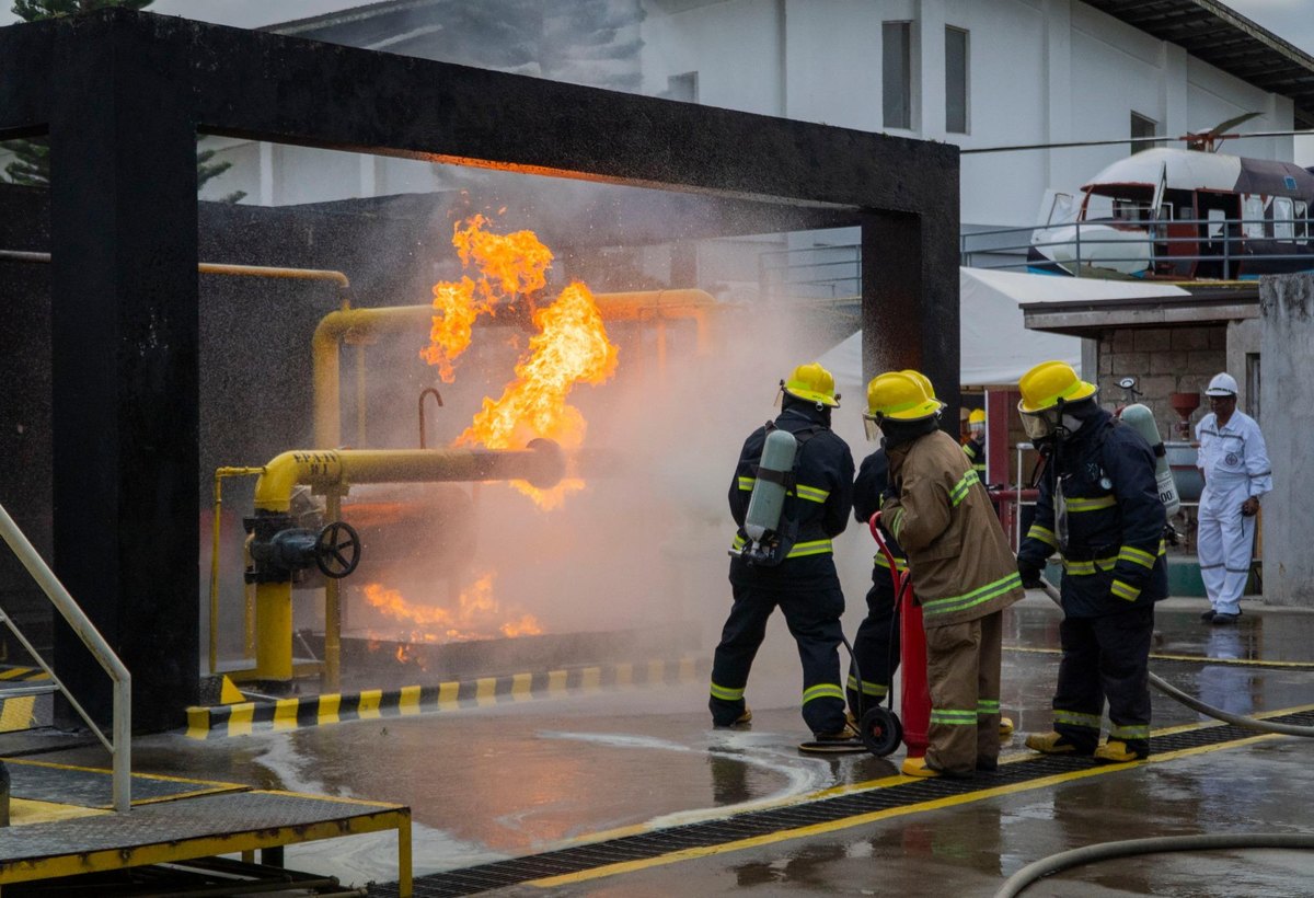 Firefighter trainees studying and applying procedures during practical training